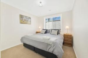 a bedroom with a large bed and a window at Prime on Piper in Bathurst