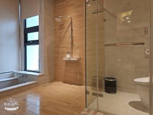a bathroom with a shower with a glass door at Mysig Villa in Ch'eng-kung-li