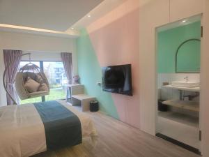 a bedroom with a bed and a sink and a tv at Mysig Villa in Ch'eng-kung-li +38 photos