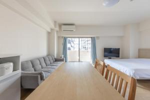a living room with a bed and a couch at Jintai House201 in Fukuoka