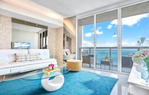 a living room with a white couch and a large window at Brickell by Miami Vacation Rentals in Miami