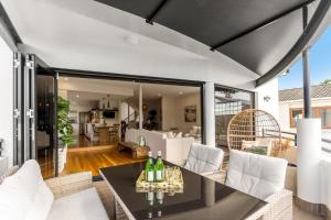 a living room with a table and chairs at Luxurious Beachside Oasis with Ocean Views in Gold Coast