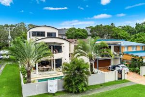 an aerial view of a house with palm trees at Luxurious Beachside Oasis with Ocean Views in Gold Coast