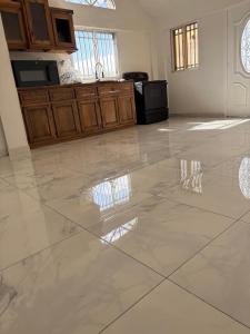 a kitchen with a large tile floor in a house at VIP Hotel Haiti in Port-de-Paix +35 photos