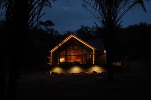 a glass house at night with lights on it at Recanto dos Licuris in Lençóis