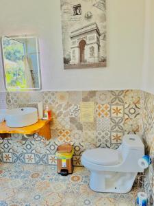 a bathroom with a toilet and a sink at TIBERIAS by luxury Atitlan in San Pedro La Laguna +30 photos