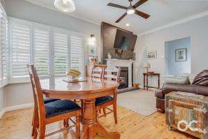 a dining room with a table and chairs and a couch at Wollemi Cottage Orange in Orange +7 photos