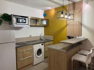 a kitchen with a washer and dryer in a room at Studio en bord de mer - létama - Résidence Archipel Savane in Le Gosier