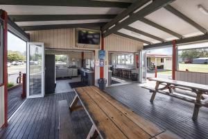 a porch with a wooden bench on a building at Reflections Evans Head - Holiday Park in Evans Head