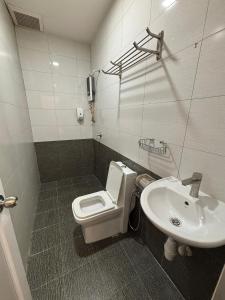 a bathroom with a toilet and a sink at One Point Hotel @ Airport (Kuching) in Kuching
