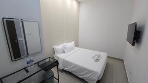 a hospital room with a white bed and a mirror at One Point Hotel @ Airport (Kuching) in Kuching +18 photos
