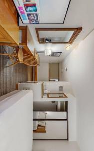 a small kitchen with white appliances and wooden ceilings at 3 bdrm cottage in Predeal in Predeluţ