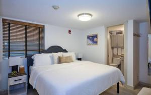 a bedroom with a large white bed and a bathroom at 3 bdrm cottage in Predeal in Predeluţ