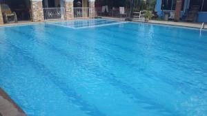 a large swimming pool with blue water at Phafan pool villa in Ban Pa Sang (1)