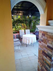 a patio with a white table and chairs at Phafan pool villa in Ban Pa Sang (1)