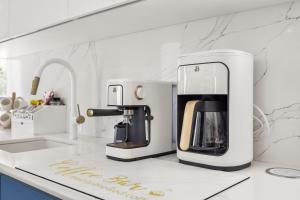 a kitchen with a coffee maker on a counter at Casa Blue Laguna II |"Tropical Escape with Ocean Views I Steps to Bio Bay & Seven Seas I Guest Discounts on Boat Tours" in Fajardo