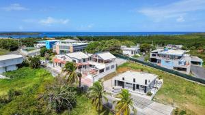 an aerial view of a house with the ocean in the background at Casa Blue Laguna II |"Tropical Escape with Ocean Views I Steps to Bio Bay & Seven Seas I Guest Discounts on Boat Tours" in Fajardo