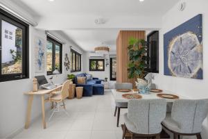 a living room with a table and a blue couch at Casa Blue Laguna II |"Tropical Escape with Ocean Views I Steps to Bio Bay & Seven Seas I Guest Discounts on Boat Tours" in Fajardo
