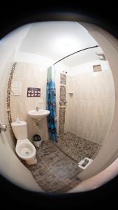 a bathroom with a toilet and a sink at Hostal Paz y Vida in Medellín +105 photos