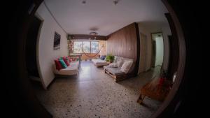 a hallway with a living room with couches and a table at Hostal Paz y Vida in Medellín
