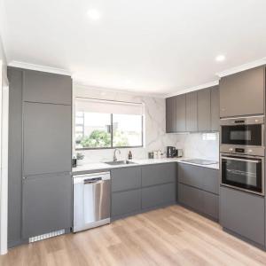a kitchen with stainless steel appliances and a window at Lakeside Breeze in Jindabyne