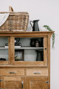 a wooden cabinet with a basket on top of it at Old Maffra Cottage in Maffra