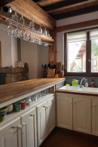 a kitchen with white cabinets and a sink and a window at The chalet of time in Eyne +12 photos