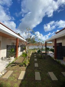a garden with trees in the middle of a house at Ramaiin guest house in Nusa Dua