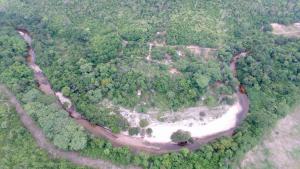 an aerial view of a forested area with a river at Recanto dos Licuris in Lençóis +53 photos