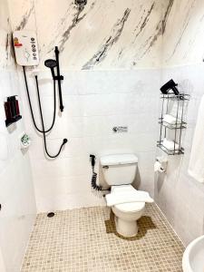 a bathroom with a toilet and a shower at Top Residence Patong in Patong Beach +13 photos