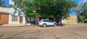 a white car parked on the side of a street at Hospedaje JyH in Paso de los Libres