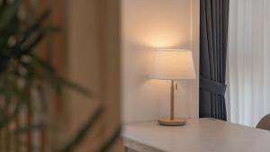 a lamp sitting on a table in a room at Chuncheon The Van Pool Villa in Chuncheon