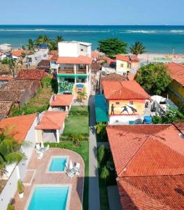an aerial view of houses and the ocean at Condomínio Diver in Vera Cruz de Itaparica