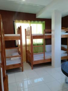 a room with several bunk beds in a room at MJ's Guesthouse in Tubod