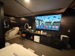 a room with a large tv on a wall at Dalbit Sori Hotel Jeonju in Jeonju