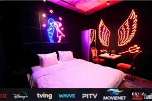 a bedroom with a bed with neon lights on it at Dalbit Sori Hotel Jeonju in Jeonju +18 photos
