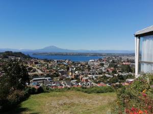 a view of a city from a hill at Vista volcanes house in Puerto Varas
