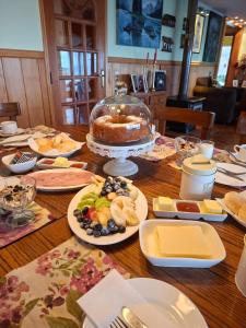 a table with a cake and plates of food on it at Vista volcanes house in Puerto Varas