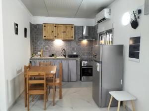 a kitchen with a table and a refrigerator at Toscana Apartamentos in Progreso