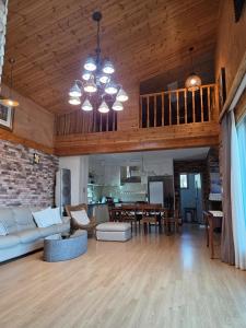 a living room with a couch and a dining room at Yangpyeong Mulsori Supbaram in Yangpyeong
