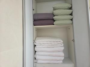 a closet with a stack of folded towels at Yangpyeong Mulsori Supbaram in Yangpyeong