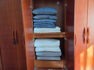 a closet with a stack of folded towels at Yangpyeong Mulsori Supbaram in Yangpyeong +39 photos