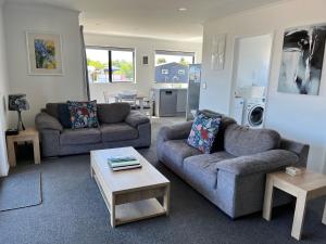 a living room with two couches and a coffee table at Mountain views on Mackenzie in Twizel