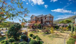 a large house with a garden in front of it at Buan Pension Maple in Buan