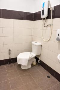 a bathroom with a toilet and a shower at EL Zahraa Moda Hotel Alor Setar in Alor Setar +4 photos
