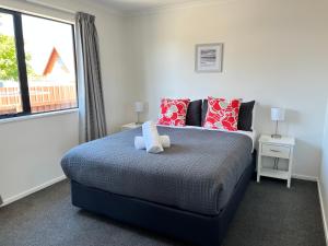 a bedroom with a bed with a teddy bear on it at Mountain views on Mackenzie in Twizel