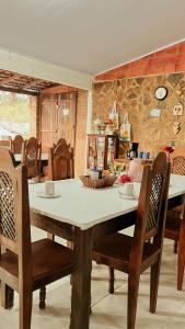 a dining room with a table and some chairs at Chalés São Domingos in Barreirinhas