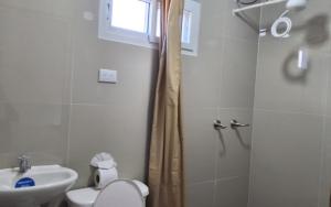 a bathroom with a shower and a toilet and a sink at BCHotel in Siguatepeque