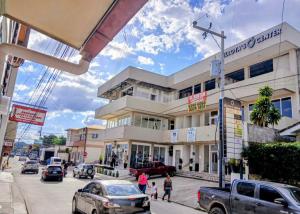 a building on a street with cars parked in front of it at BCHotel in Siguatepeque +19 photos