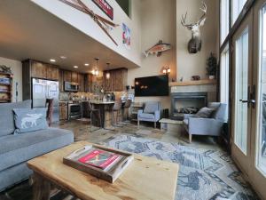 a living room with a couch and a table at Kirkwood Mountainside Cabin & Cottage Deck wViews in Kirkwood